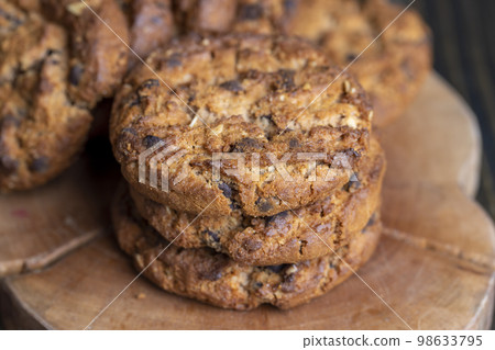 Delicious cookies with pieces of chocolate on the table Delicious cookies with pieces of chocolate on the table 98633795