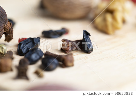 Dried clove spices on the board 98633858
