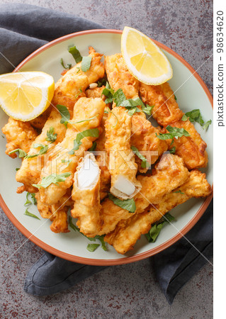 Fried Spanish Squid Rabas Fritas closeup on the plate. Vertical top view 98634620