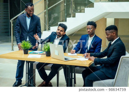 Group of business international people looking at the graph on flipchart in modern eco office 98634739