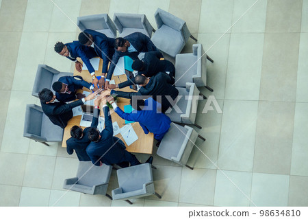top view of team work high five a group of successful afro americans, europeans ,arabic and korean businessman and businesswoman working 98634810