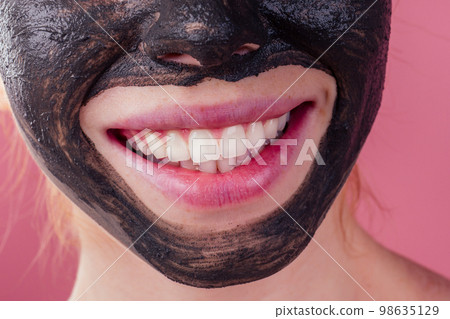 redhaired ginger young caucasian woman with natural anti acne mask on her pretty perfect face in studio pink background redhaired ginger young caucasian woman with natural anti acne mask on her pretty perfect face in studio pink background 98635129