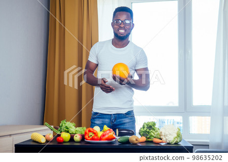 afro american male cooking something tasty for his girlfriend. ready to romantic date afro american male cooking something tasty for his girlfriend. ready to romantic date 98635202