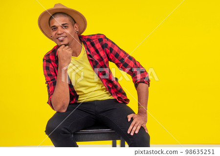 arabic brazilian man posing at studio in yellow background arabic brazilian man posing at studio in yellow background 98635251