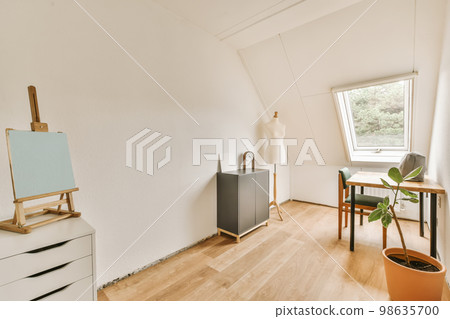 a room with white walls and wood flooring, including a large window that looks out onto the trees outside 98635700