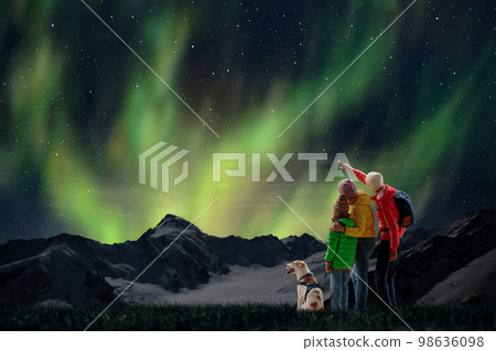Family watching northern lights. Aurora night sky. 98636098