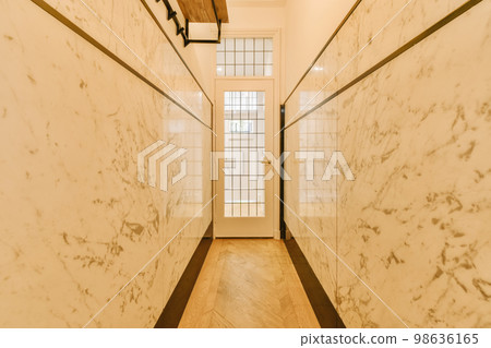 a long hallway with white marble on the walls and wood trim around the wall to make it look like an art deco 98636165