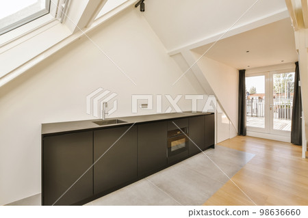 a kitchen area in a house with skylights on the roof and an open door leading out to the balcony a kitchen area in a house with skylights on the roof and an open door leading out to the balcony 98636660