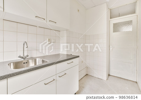a kitchen with white cabinets and black granite counter tops on the counter top in this photo is taken to the left a kitchen with white cabinets and black granite counter tops on the counter top in this photo is taken to the left 98636814