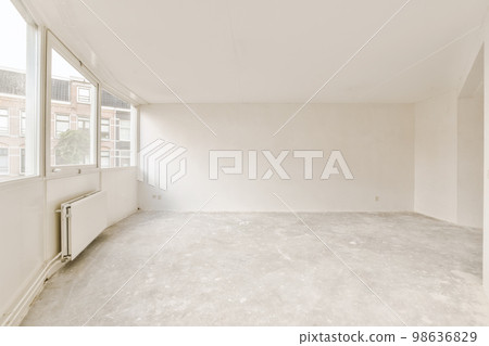an empty room with no one on the floor and windows in the photo is taken out to show how it's going 98636829