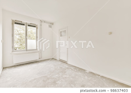 an empty room with white walls and no one person standing in the corner looking out to the other side window an empty room with white walls and no one person standing in the corner looking out to the other side window 98637403