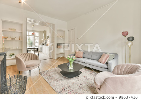 The interior of a spacious living room in an open design with a big sofa and carpet in a cozy house The interior of a spacious living room in an open design with a big sofa and carpet in a cozy house 98637416