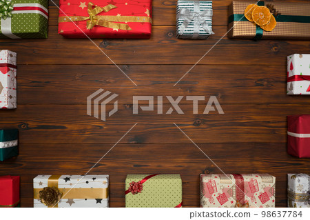 Colorful gift boxes framing a blank copy space on a desktop, top view. 98637784