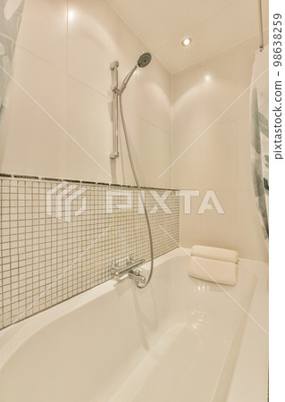 a man in the shower is on the wall above the bathtub and it's next to the toilet a man in the shower is on the wall above the bathtub and it's next to the toilet 98638259