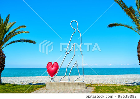 A sculpture in the shape of a golfer. Scenery of a modern city A sculpture in the shape of a golfer. Scenery of a modern city 98639882