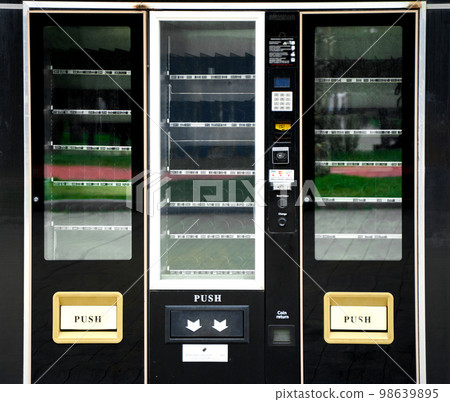 A newly installed vending machine, not yet filled with products. Empty display case of the vending machine A newly installed vending machine, not yet filled with products. Empty display case of the vending machine 98639895