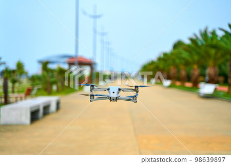 The quadcopter flies over the alley. Shooting video of the beautiful places of the city The quadcopter flies over the alley. Shooting video of the beautiful places of the city 98639897