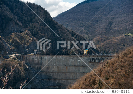 The dam of the Inguri hydroelectric power plant in the Sakartvelo mountains. A natural mountain landscape with energetic infrastructure The dam of the Inguri hydroelectric power plant in the Sakartvelo mountains. A natural mountain landscape with energetic infrastructure 98640111