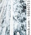 Frozen snow road the day after it snowed 98640753