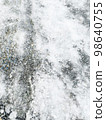 A sidewalk that has become an ice barn 98640755