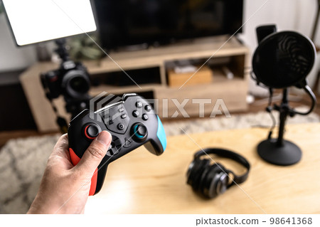 Arranging the equipment for game distribution Single-lens reflex camera, microphone and controller headphones YouTuber playing the game 98641368