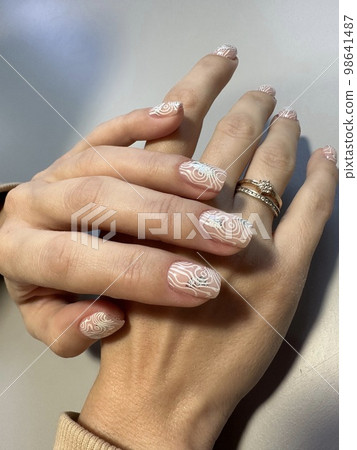 Closeup photo of a beautiful female hands with elegant manicure Closeup photo of a beautiful female hands with elegant manicure 98641487