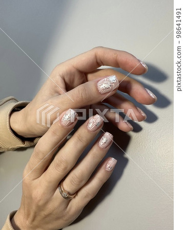 Amazing natural nails. Women's hands with clean manicure Amazing natural nails. Women's hands with clean manicure 98641491