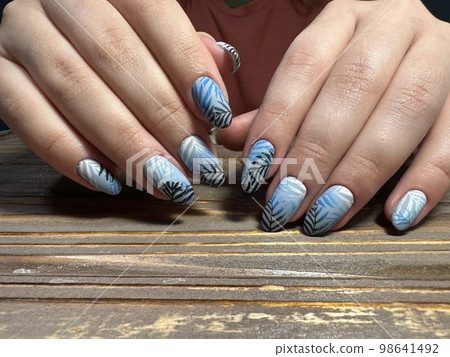 Trendy manicure design on a beautiful background. Trendy manicure design on a beautiful background. 98641492