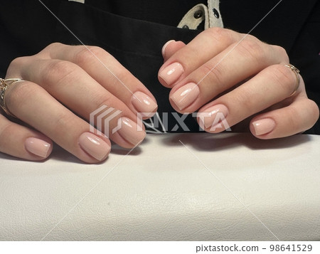 Trendy manicure design on a beautiful background. Trendy manicure design on a beautiful background. 98641529