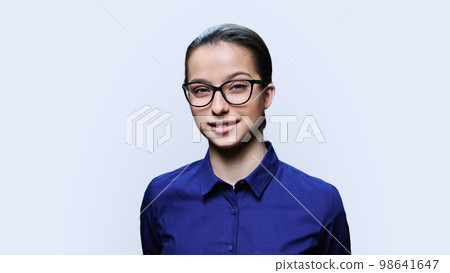 Teenage girl student in glasses looking at camera on white background 98641647
