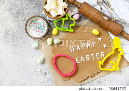 Background for baking or cooking Easter cookies. Ingredients and kitchen utensils for baking on a light stone table. View from above. Copy space. 98641765