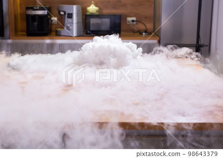 Smoke vapor dry ice in bowl in kitchen 98643379