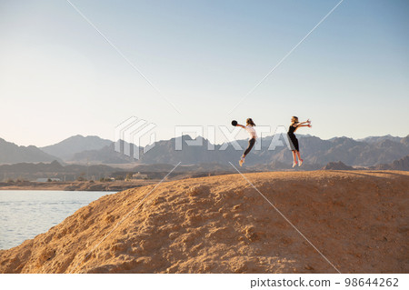 Two nice women dressed in casual clothes 98644262