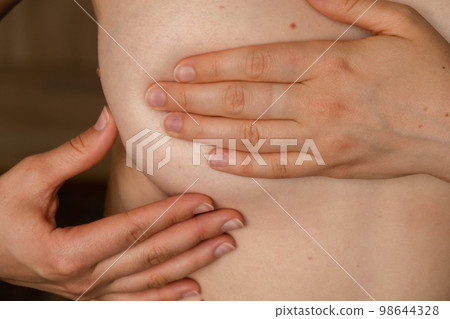 Unrecognizable Women topless doing self-checks for breast cancer. BSE Checking up breast changes, possible lumps, distortions or swelling. Breast cancer awareness 98644328