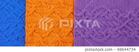 Knitted blue, lilac and orange background. Large knitted fabric with a pattern. Close-up of a knitted blanket. Banner Knitted blue, lilac and orange background. Large knitted fabric with a pattern. Close-up of a knitted blanket. Banner 98644734