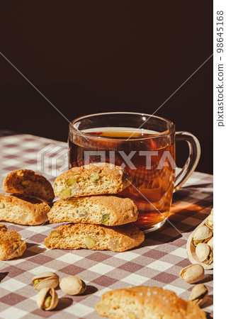 Biscotti Cantuccini Cookie Biscuits with pistachios and lemon peel Shortbread. Cup of tea. Teatime break Healthy eating food. Homemade fresh Italian cookies cantucci stacks and organic pistachios nuts 98645168