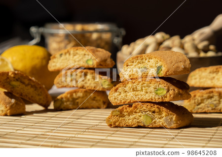 Biscotti Cantuccini Cookie Biscuits with pistachios and lemon peel Shortbread. Healthy eating food. Homemade fresh Italian cookies cantucci stacks and organic pistachios nuts. Vegan dieting 98645208