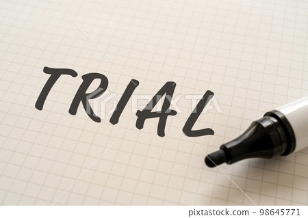 A notebook and a marker that says TRIAL 98645771