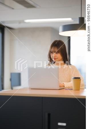 A young woman using a laptop A young woman using a laptop 98646750