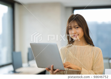 A young woman using a laptop A young woman using a laptop 98646752
