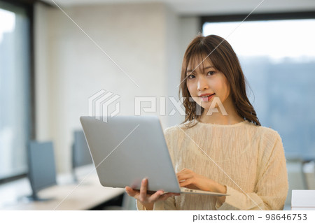 A young woman using a laptop A young woman using a laptop 98646753