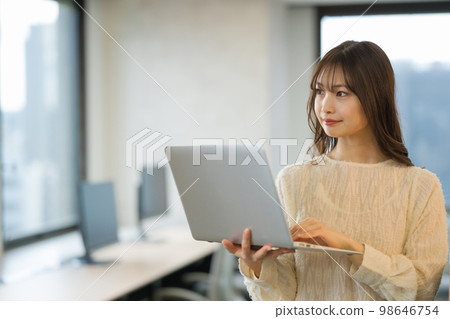 A young woman using a laptop A young woman using a laptop 98646754