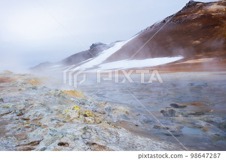 Geothermal Area in Iceland. Smoking Fumaroles. Real Volcanic Activity. Evaporating water. Hverir Geothermal Area in Iceland. Smoking Fumaroles. Real Volcanic Activity. Evaporating water. Hverir 98647287