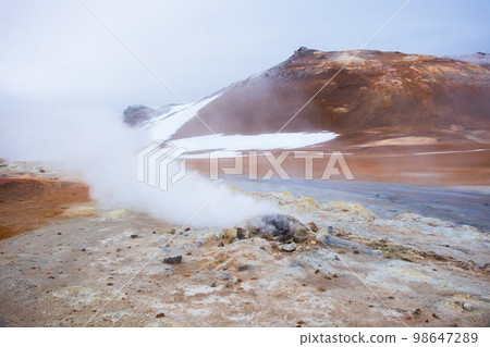Geothermal Area in Iceland. Smoking Fumaroles. Real Volcanic Activity. Evaporating water. Hverir Geothermal Area in Iceland. Smoking Fumaroles. Real Volcanic Activity. Evaporating water. Hverir 98647289