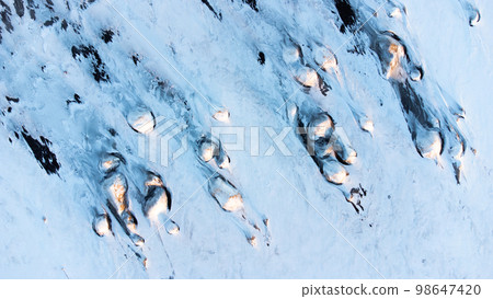 Winter Landscape in Iceland. Snow Covered Hills On The Ocean Shore. Abstract Winter Landscape in Iceland. Snow Covered Hills On The Ocean Shore. Abstract 98647420