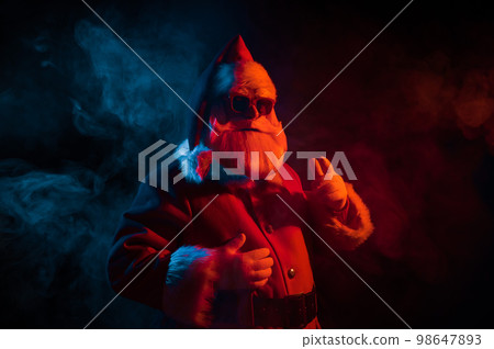 Portrait of Santa Claus in sunglasses in neon light. Portrait of Santa Claus in sunglasses in neon light. 98647893