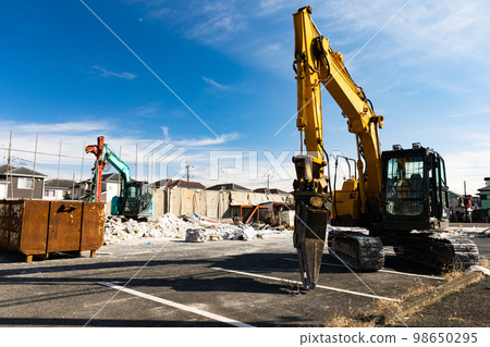 Demolition work site Heavy backhoe 98650295