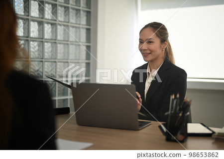 Millennial female recruitment manager listening female candidate about her work experience during job interview Millennial female recruitment manager listening female candidate about her work experience during job interview 98653862