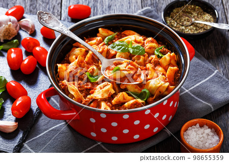 tortellini in ground beef tomato sauce, top view tortellini in ground beef tomato sauce, top view 98655359