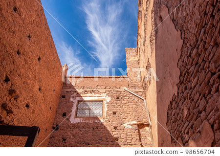 inside of a clay kasbah with a modern window on a sunny day inside of a clay kasbah with a modern window on a sunny day 98656704